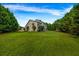 Expansive backyard with lush green lawn and mature trees offering privacy and plenty of space at 15 Saddlebrook Ct, Covington, GA 30016