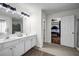Bright and spacious bathroom features double sinks, a large mirror, and modern finishes at 15 Saddlebrook Ct, Covington, GA 30016