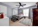 Serene bedroom featuring natural light, neutral walls, black canopy bed, and carpeted floors at 15 Saddlebrook Ct, Covington, GA 30016