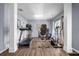 Bright exercise room featuring modern equipment and hardwood floors at 15 Saddlebrook Ct, Covington, GA 30016