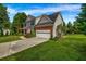 Exterior side view showing lawn, driveway, and two-car garage of home in a nicely landscaped yard at 15 Saddlebrook Ct, Covington, GA 30016