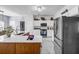 Modern kitchen with stainless steel appliances, white cabinets, and island with seating at 15 Saddlebrook Ct, Covington, GA 30016