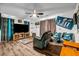 Entertainment-ready living room with sleek flooring, big-screen TV, and comfortable seating at 15 Saddlebrook Ct, Covington, GA 30016