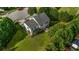 Aerial view of the home with a large lawn and mature trees at 15 Saddlebrook Ct, Covington, GA 30016