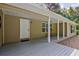 Covered back porch with ample seating area and exterior lighting at 3440 Wilson Rd, South Fulton, GA 30349