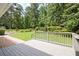 Spacious wooden porch overlooking the backyard's lush greenery and well-maintained landscaping at 3440 Wilson Rd, South Fulton, GA 30349