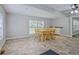 Inviting dining area with neutral color palette, tile floors, and an adjacent bonus area at 3440 Wilson Rd, South Fulton, GA 30349