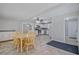 Open-concept dining area with tile floors, adjacent to the kitchen and overlooking the backyard at 3440 Wilson Rd, South Fulton, GA 30349