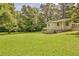 A home set in an expansive green backyard with mature trees at 3440 Wilson Rd, South Fulton, GA 30349