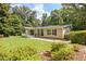 Ranch style home with a well-manicured lawn, mature trees, and covered porch at 3440 Wilson Rd, South Fulton, GA 30349