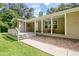 Inviting covered front porch with ample seating space, stone landscaping and shade at 3440 Wilson Rd, South Fulton, GA 30349