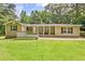 Charming ranch-style home with a welcoming front porch, lush green lawn and mature trees at 3440 Wilson Rd, South Fulton, GA 30349