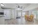 Open kitchen with tiled floor, white cabinets, and wooden dining table with four chairs at 3440 Wilson Rd, South Fulton, GA 30349