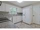 Well-lit kitchen with white cabinets, stainless steel appliances, and access to a side entry door at 3440 Wilson Rd, South Fulton, GA 30349