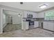 Bright kitchen with stainless steel appliances, white cabinets, and an opening to the living room at 3440 Wilson Rd, South Fulton, GA 30349