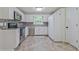 Well-lit kitchen featuring white cabinets, stainless steel appliances, and neutral granite countertops at 3440 Wilson Rd, South Fulton, GA 30349