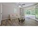 Sunlit living room with wood floors and view of a screened-in patio at 3440 Wilson Rd, South Fulton, GA 30349