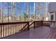 Large wooden deck with railings, perfect for enjoying the wooded views at 5050 Brownwood Dr, Powder Springs, GA 30127