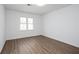 Bright bedroom with wood flooring and a window overlooking the yard at 5050 Brownwood Dr, Powder Springs, GA 30127