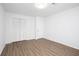 Bedroom featuring closet, wood look floors, and neutral paint at 5050 Brownwood Dr, Powder Springs, GA 30127