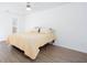 Bright bedroom features a ceiling fan, white walls and light wood grain flooring at 5050 Brownwood Dr, Powder Springs, GA 30127