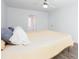 Bright bedroom features a ceiling fan, white walls and light wood grain flooring at 5050 Brownwood Dr, Powder Springs, GA 30127