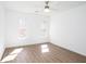 Bedroom with two windows for abundant natural light and neutral walls at 5050 Brownwood Dr, Powder Springs, GA 30127