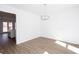 A bright dining room with stylish light fixture and sleek, light-colored flooring at 5050 Brownwood Dr, Powder Springs, GA 30127