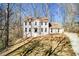 Inviting two-story home with a well-maintained yard and a classic architectural design at 5050 Brownwood Dr, Powder Springs, GA 30127