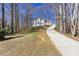 Charming two-story home nestled on a hill with a long driveway and surrounded by mature trees at 5050 Brownwood Dr, Powder Springs, GA 30127