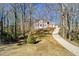 Beautiful two-story home with a long drive and set among mature trees at 5050 Brownwood Dr, Powder Springs, GA 30127