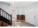 Entryway featuring hardwood floors, wainscotting and a white front door with decorative glass at 5050 Brownwood Dr, Powder Springs, GA 30127