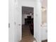Bright hallway with a view of the living room fireplace and a bathroom vanity at 5050 Brownwood Dr, Powder Springs, GA 30127