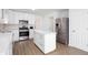 Kitchen with white cabinets, stainless steel appliances, and an island with white countertop at 5050 Brownwood Dr, Powder Springs, GA 30127