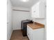 Efficient laundry room with modern washer/dryer, storage cabinets, and a practical countertop for folding at 5050 Brownwood Dr, Powder Springs, GA 30127