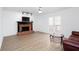 Cozy living room featuring fireplace, ceiling fan and access to backyard deck at 5050 Brownwood Dr, Powder Springs, GA 30127