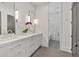 Modern bathroom boasts marble countertops, double sinks, and a glass enclosed shower at 102 Grand Cres, Alpharetta, GA 30009