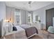 Charming bedroom with a ceiling fan, large window, and stylish furniture at 102 Grand Cres, Alpharetta, GA 30009