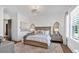This comfortable bedroom boasts a light wood bed frame and plentiful natural light at 102 Grand Cres, Alpharetta, GA 30009