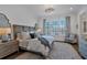 Bright bedroom features hardwood floors, a decorative ceiling fixture, and plantation shutters at 102 Grand Cres, Alpharetta, GA 30009