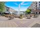 Community area with an impressive fountain surrounded by tables, chairs, and landscaping at 102 Grand Cres, Alpharetta, GA 30009