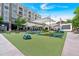 Vibrant community space with seating, shade canopies, and playful colorful accents on artificial lawn at 102 Grand Cres, Alpharetta, GA 30009