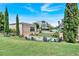 Inviting outdoor community space with lawn, seating, landscaping, and nearby shops under a bright blue sky at 102 Grand Cres, Alpharetta, GA 30009