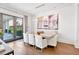 Elegant dining room with modern chandelier, seating for six, and access to the outdoor patio at 102 Grand Cres, Alpharetta, GA 30009