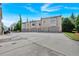 Rear view of modern residences shows garages and parking with an exterior facade of grey brick and contemporary design at 102 Grand Cres, Alpharetta, GA 30009