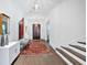 Bright foyer features hardwood floors, a decorative rug, and staircase to the right at 102 Grand Cres, Alpharetta, GA 30009