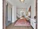 Elegant home foyer with beautiful rug, hardwood floors, and modern lighting at 102 Grand Cres, Alpharetta, GA 30009