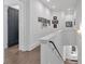 Bright hallway with hardwood floors, white walls, and dark-stained doors leading to various rooms at 102 Grand Cres, Alpharetta, GA 30009