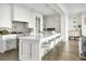 A chef's dream kitchen features an island with seating, quartz countertops, and stainless steel appliances at 102 Grand Cres, Alpharetta, GA 30009