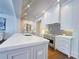 Modern kitchen boasts an island with quartz countertops, stainless steel appliances, and herringbone backsplash at 102 Grand Cres, Alpharetta, GA 30009